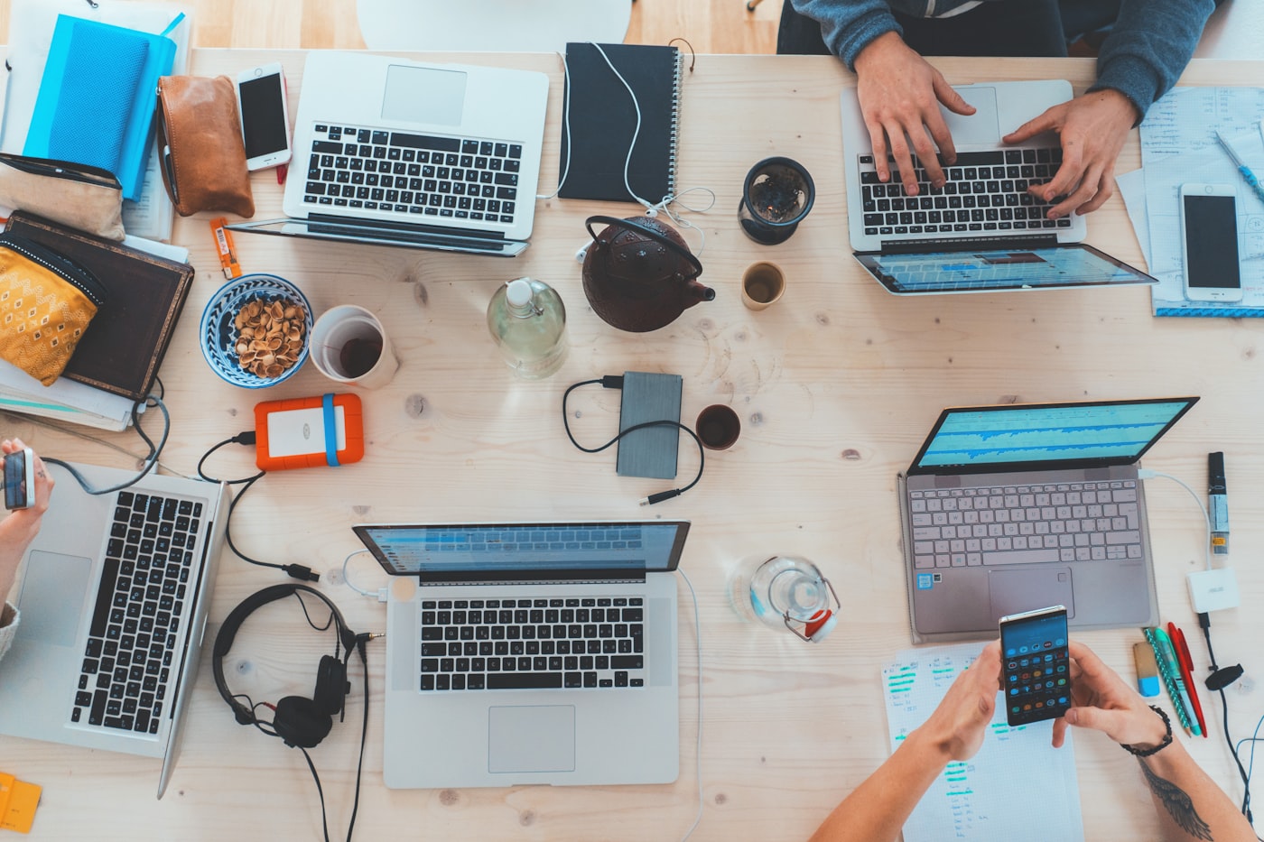 Laptops, tablets and phones arranged neatly on a desk