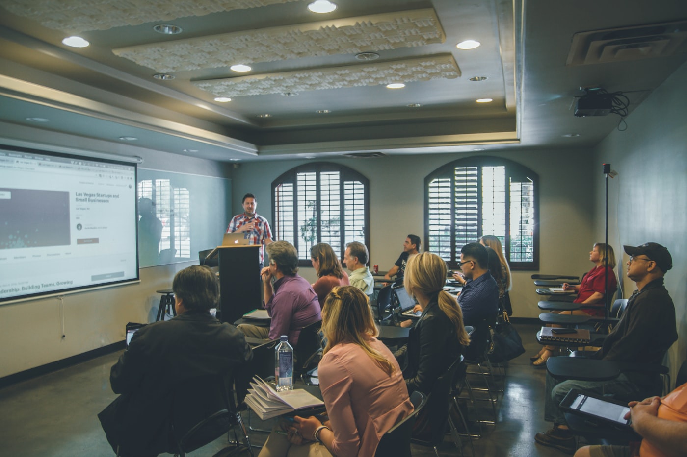 A speaker addressing an audience in a lecture hall