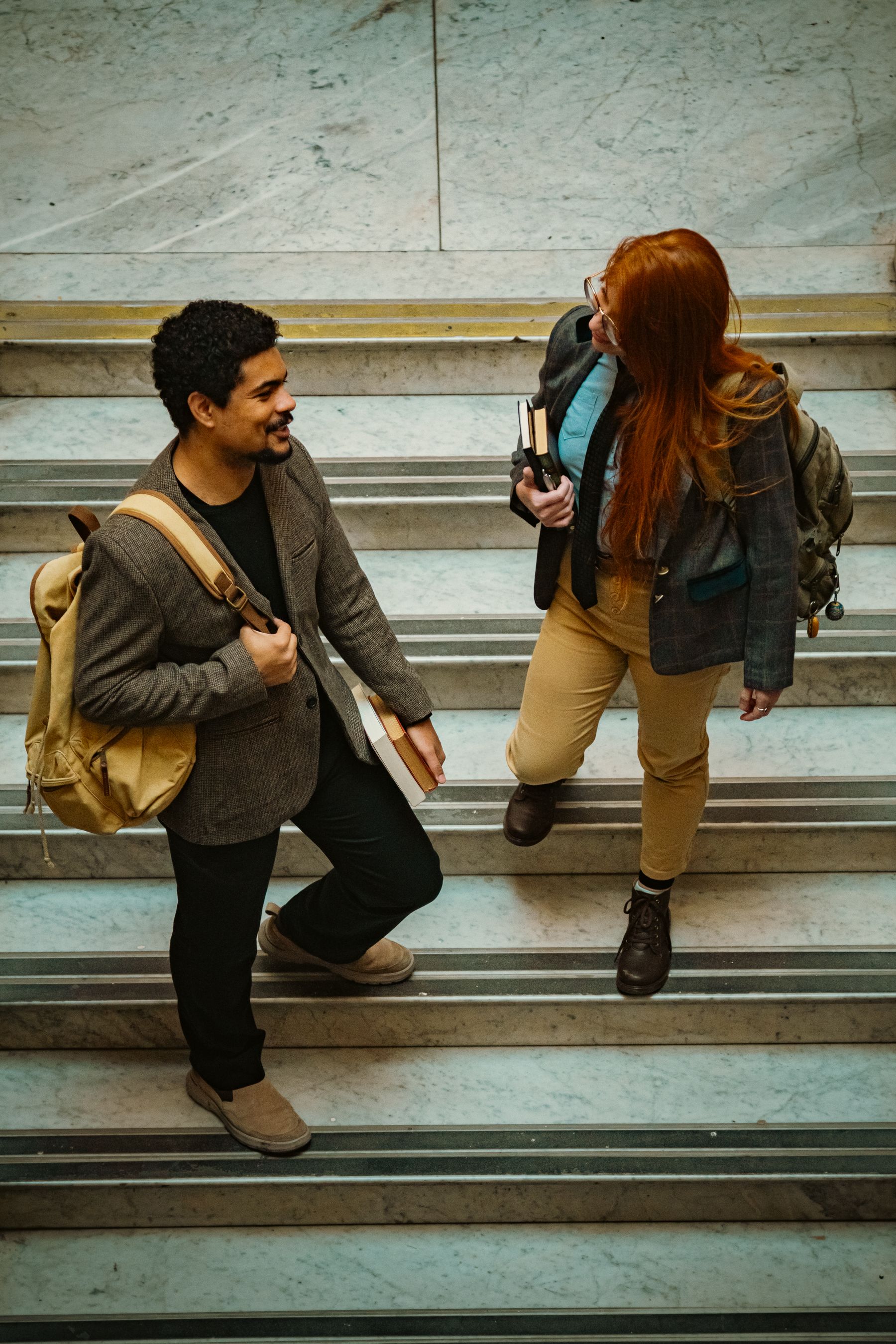 Students sitting and talking on campus steps