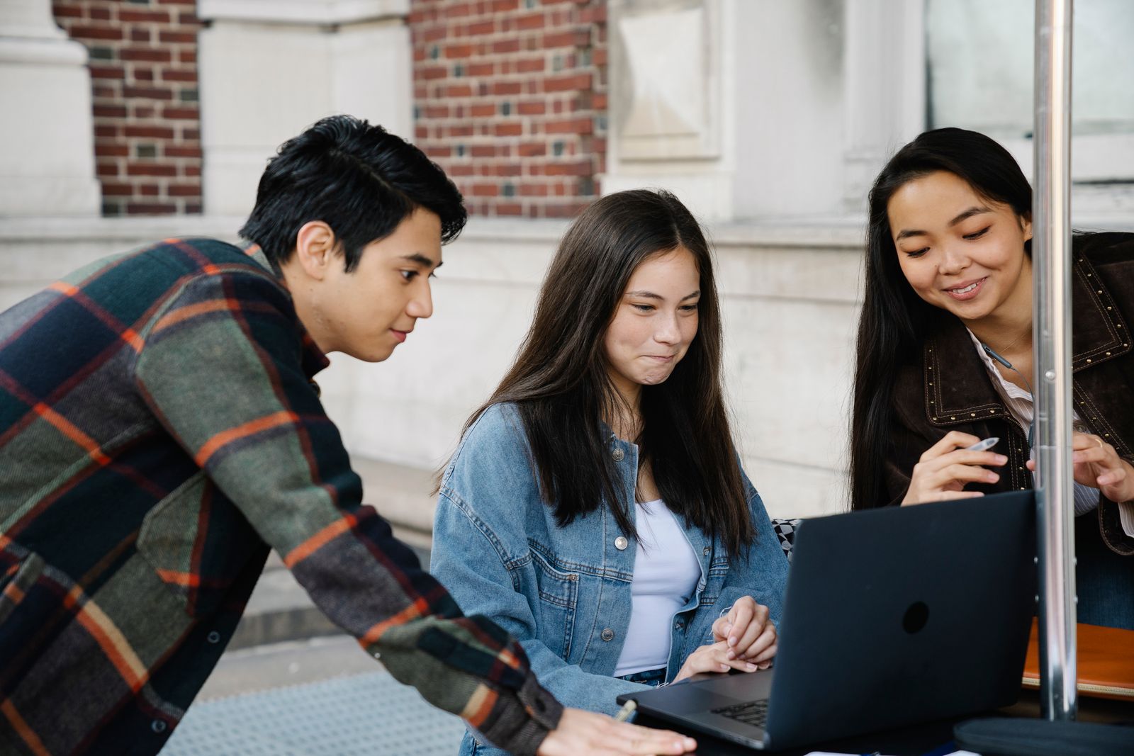 A group of young developers coding together at a shared desk