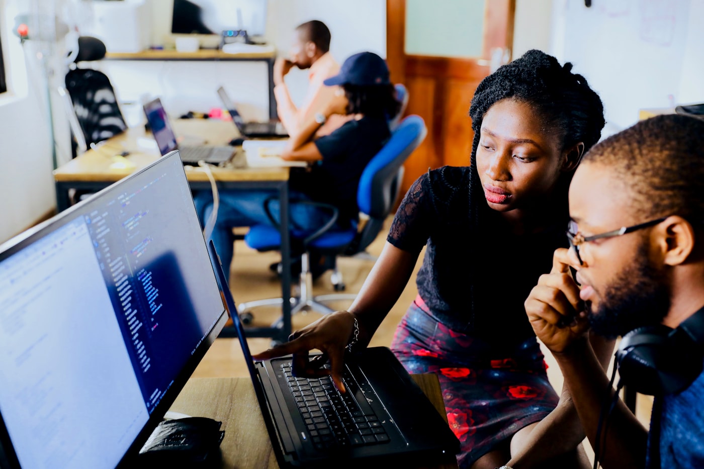 Two developers pair programming on one screen