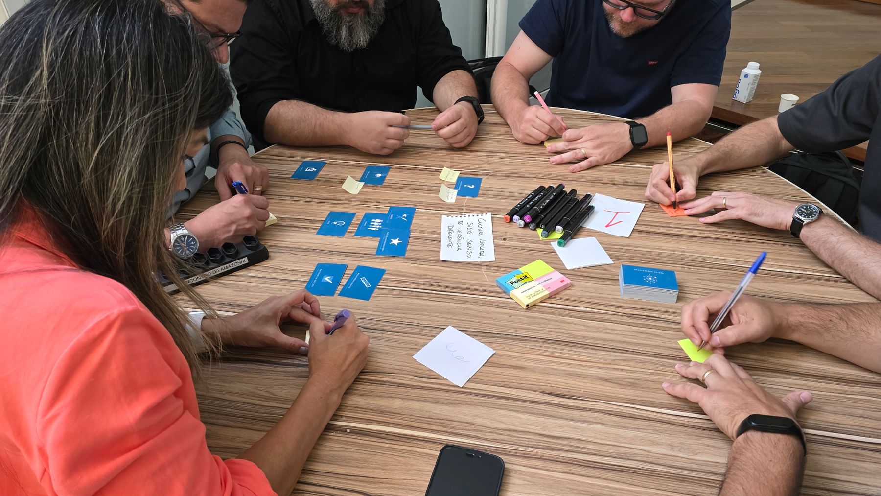 Designers arranging sticky notes during a workshop