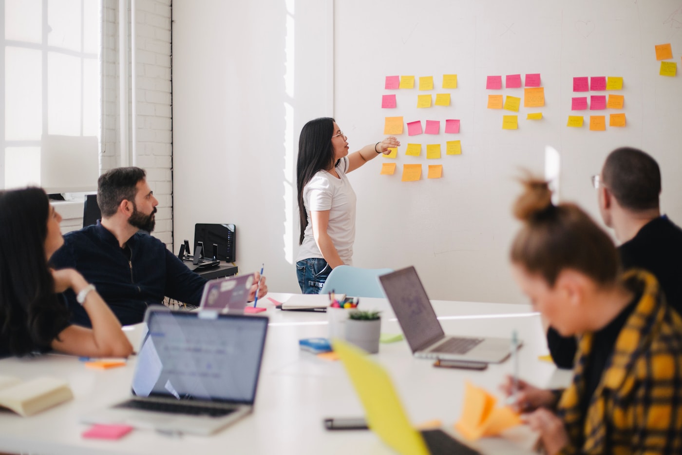 A wall covered in colourful sticky notes from an ideation session