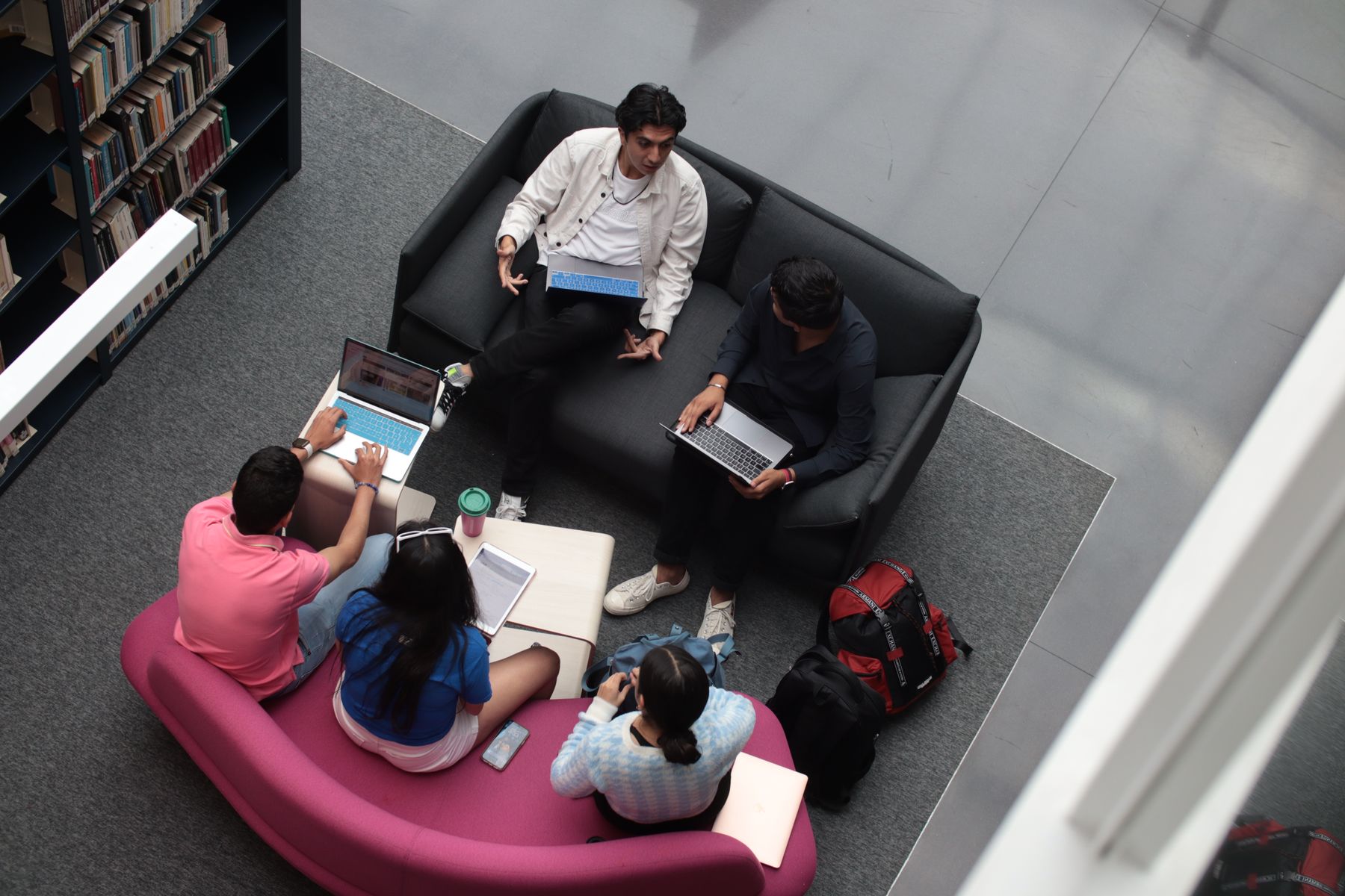 Two students collaborating at a library table