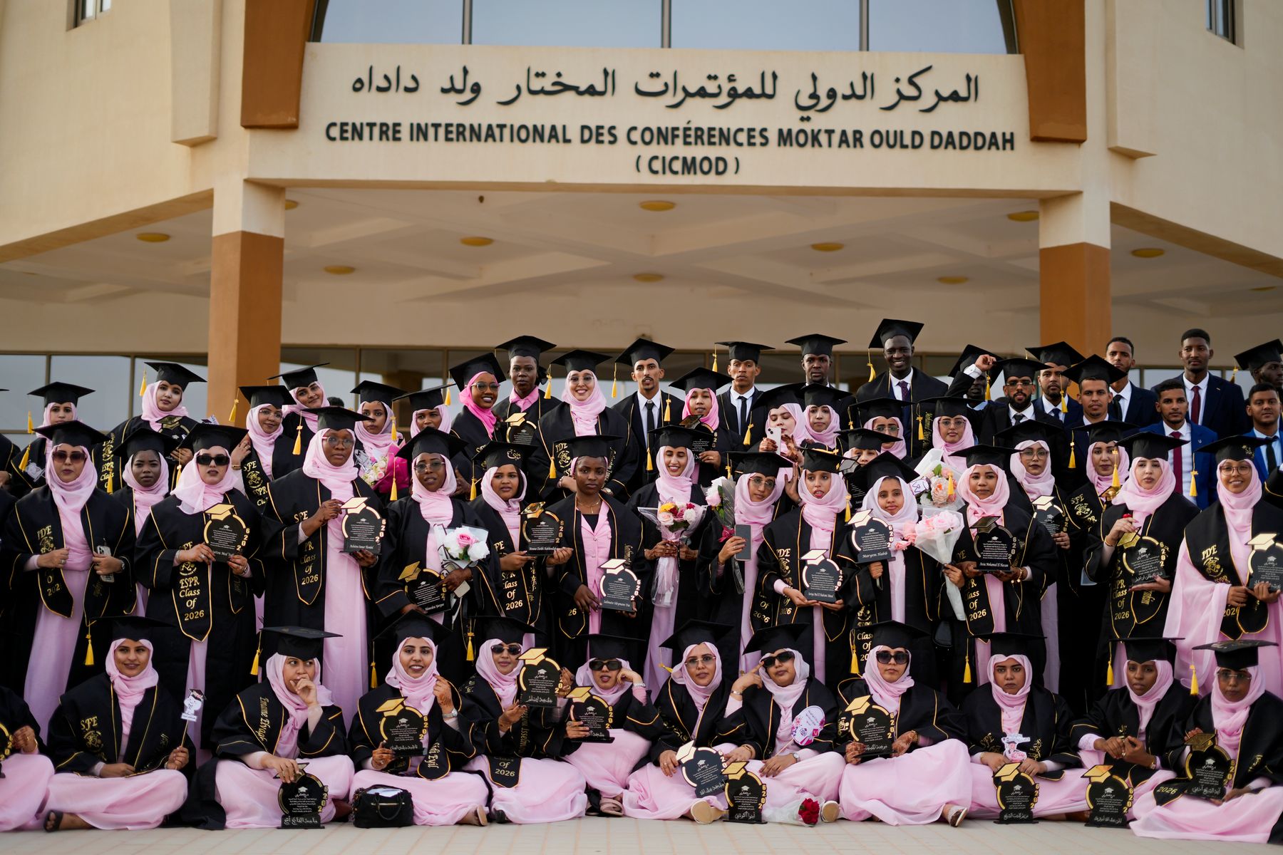 Workshop graduates holding their certificates together