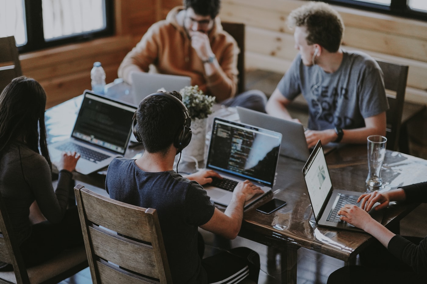 A team meeting with people discussing around a table