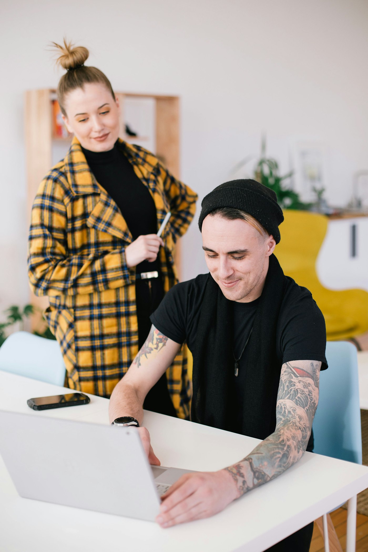 Two people sketching ideas on paper together