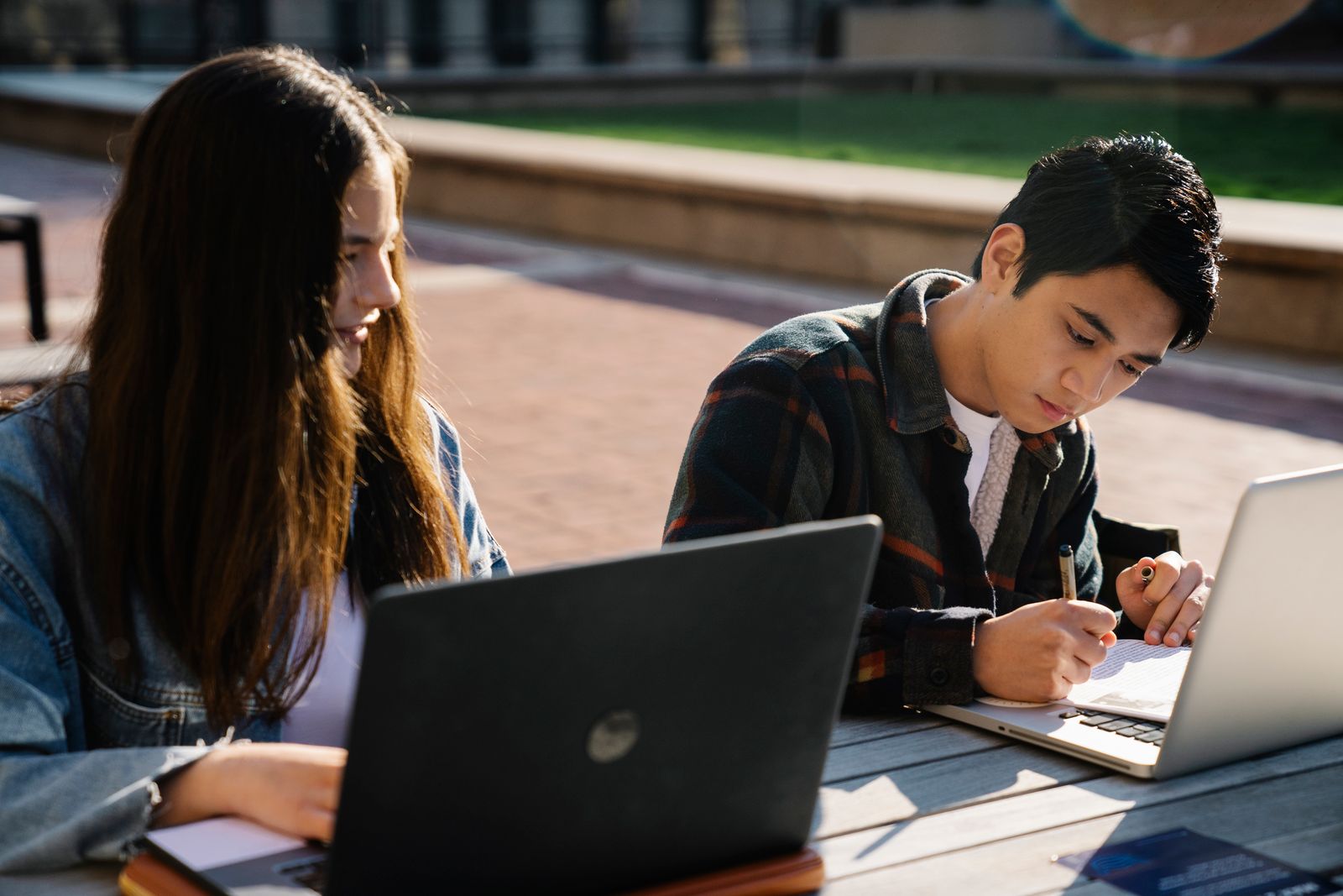Students coding together on laptops